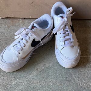 Nike Women's White Sneakers with Black Swoosh and Tan Accents